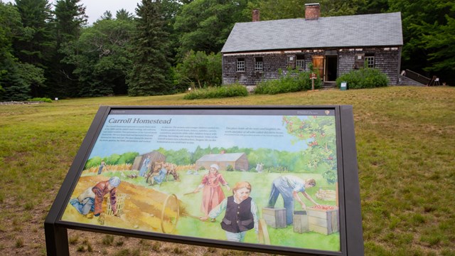Informational sign in front of historic homestead