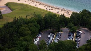 Aerial view of Sand Beach and parking area as seen from the Beehive Trail