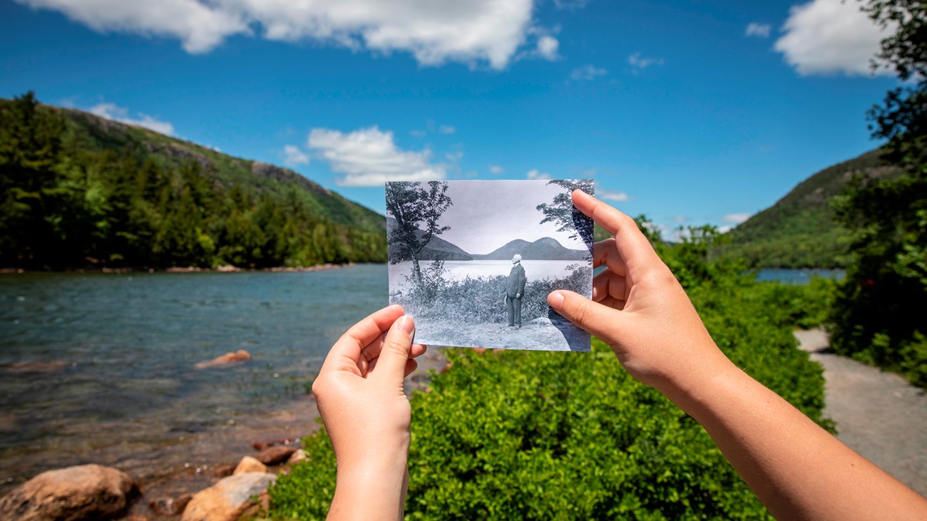 Historic photograph held in front of a landscape