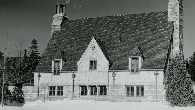 a B&W photo of a gatehouse in the snow