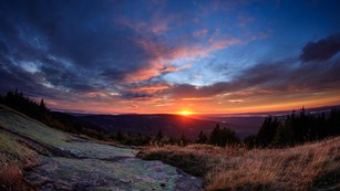 Brilliant sunset on a very cloudy night as seen from the summit of Cadillac Mountain.
