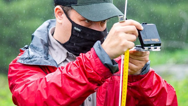 A researcher holds up a meter