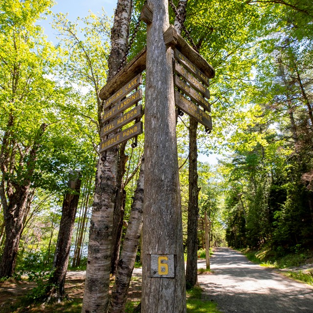 Wooden sign post with direction for carriage roads