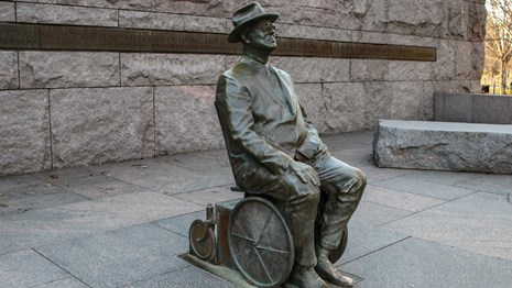 Bronze statue of man in wheelchair