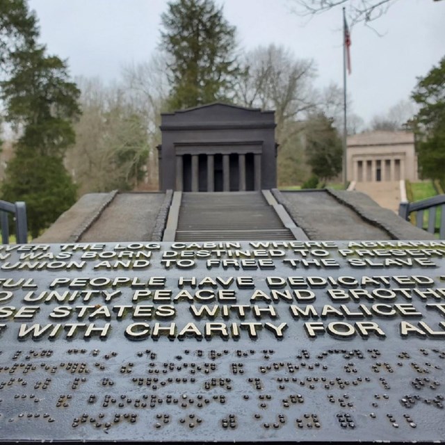 Braille Sign with steps and ramps in background leading to the Lincoln Memorial.  