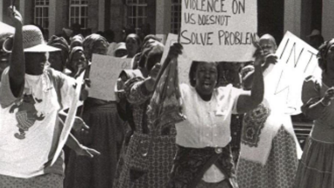 Women marching holding signs.