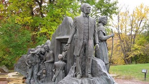 a statue of Underground Railroad conductors leading their charges