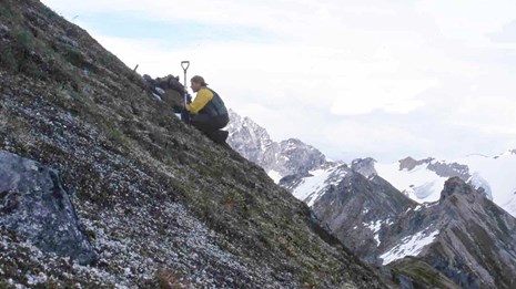 Surveying soils on steep rocky cliffs.