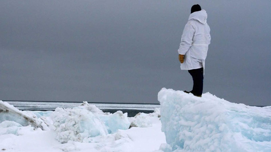 A hunter surveys the Arctic sea ice extent.