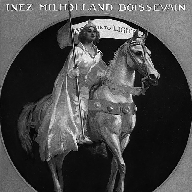 A woman holding a banner sits on top of a horse
