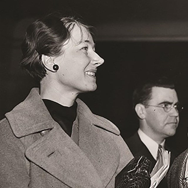 A woman smiles, it is a side profile of her face.