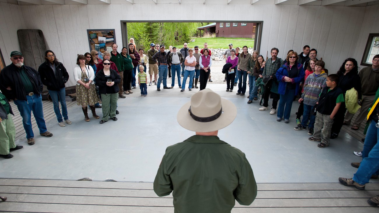 an NPS ranger speaks to a group of community members