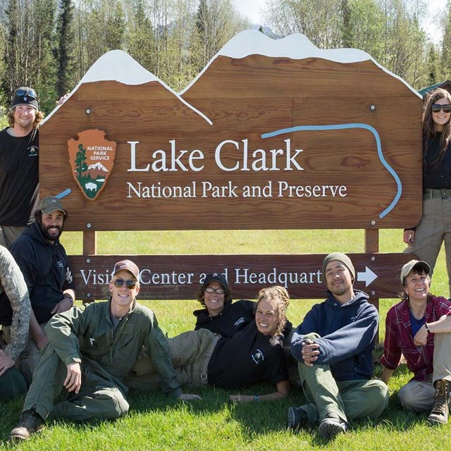 A group of National Park Staff from Lake Clark National Park & Preserve pose in front of headquarter