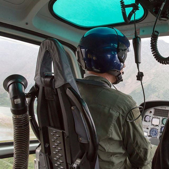 Behind view of aircraft pilot in flight.