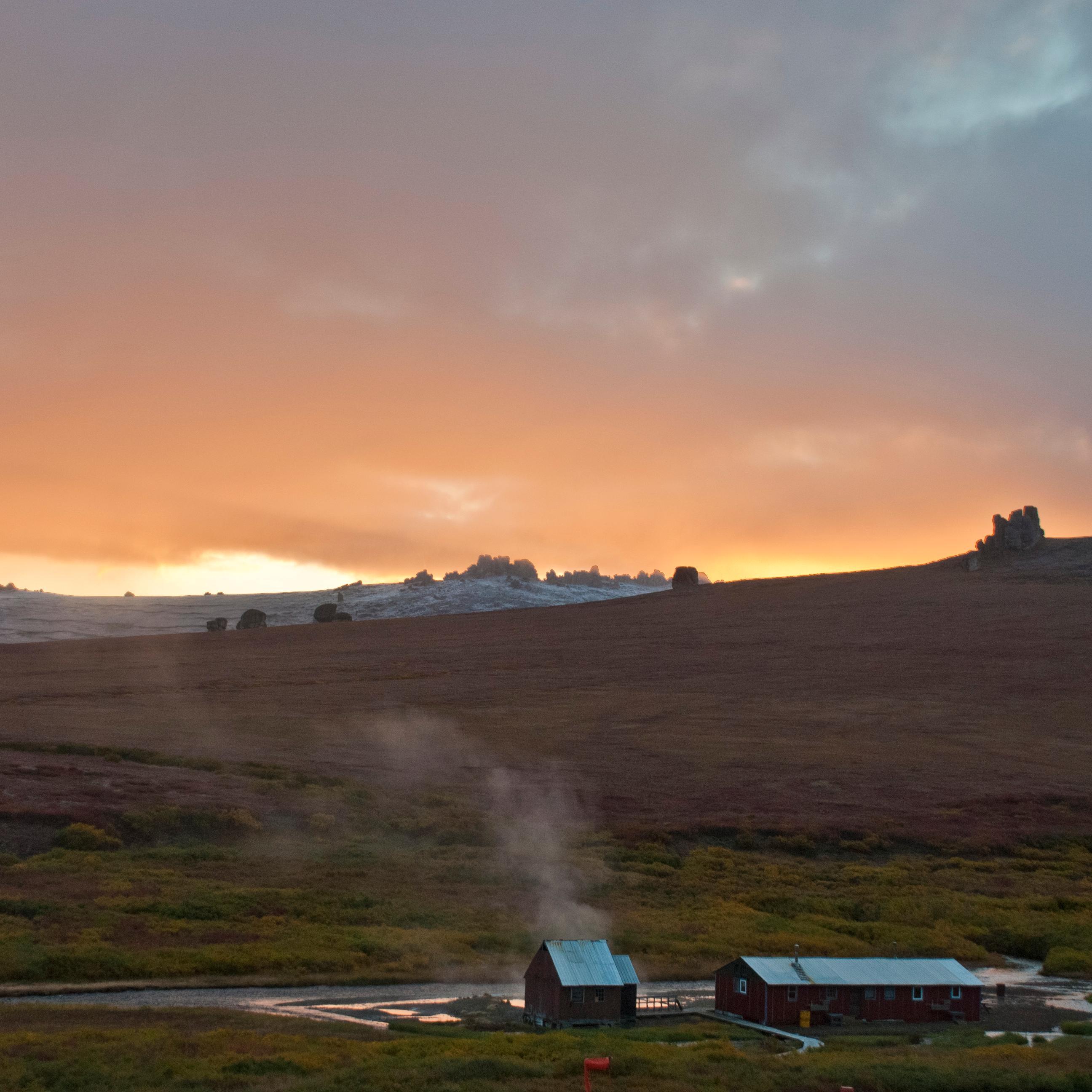 steam rises from Serpentine Hot Springs at sunset