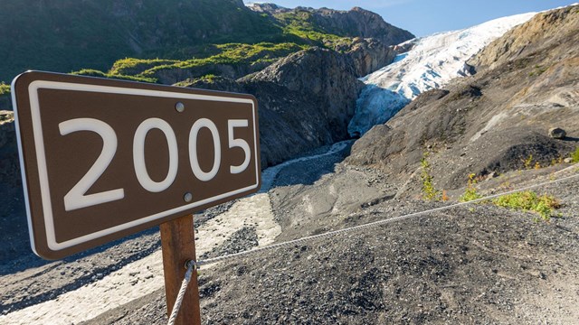 A sign marking where the end of a glacier was.