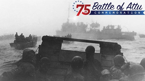 Black and white photo of men in a ship with Battle of Attu 75th commemoration text