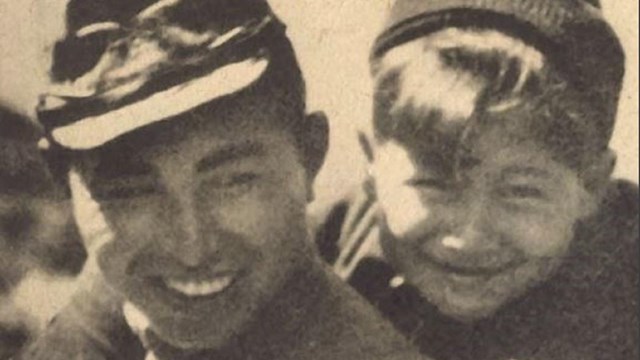 Sepia-toned cover with boy on soldier's back. Text: Attu Boy, Nick Golodoff. 