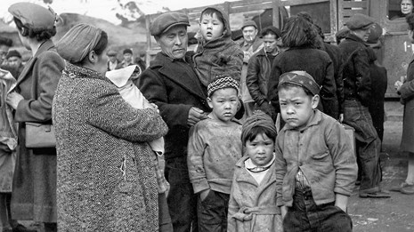 black and white image of seven children family with children gathered in a group