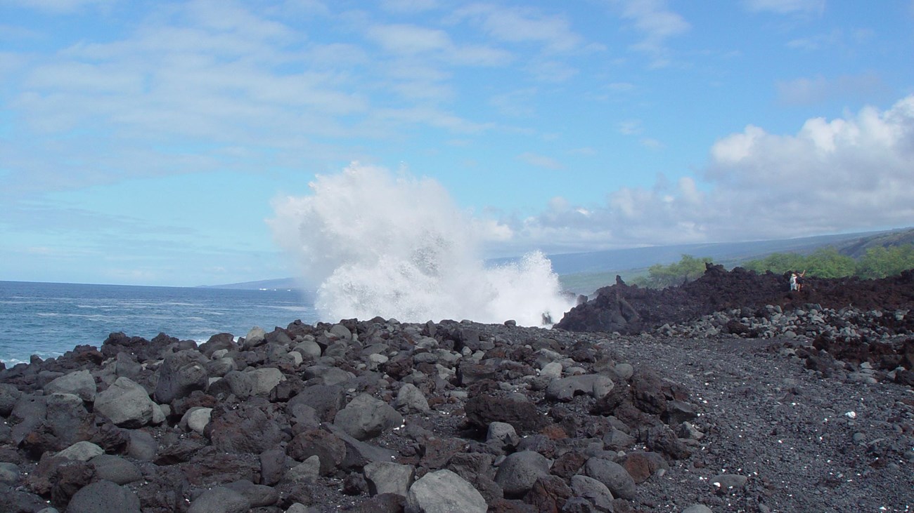 Large wave crashing over rocks