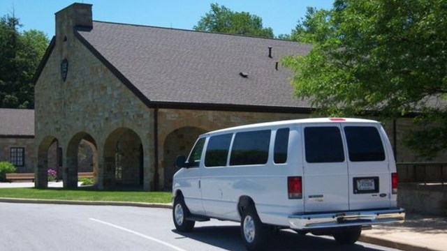 A white van parked by a building. 