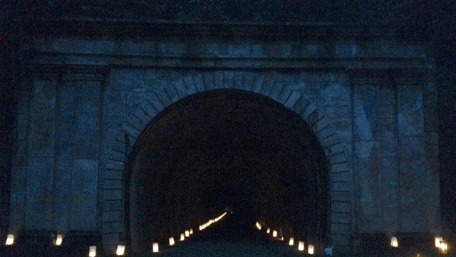 A railroad tunnel with luminaries.
