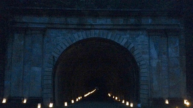 A railroad tunnel with luminaries.