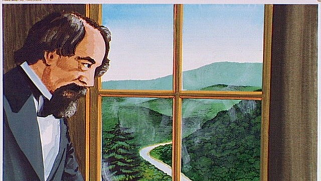 A man looking out the window of a train.