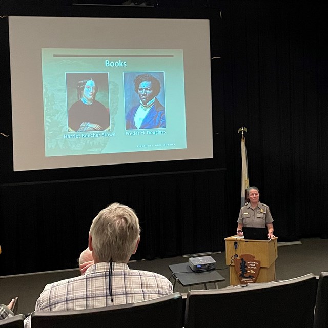 A park ranger presents a program with a PowerPoint.