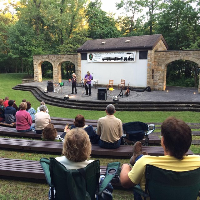 People listening to music in the amphitheater. 