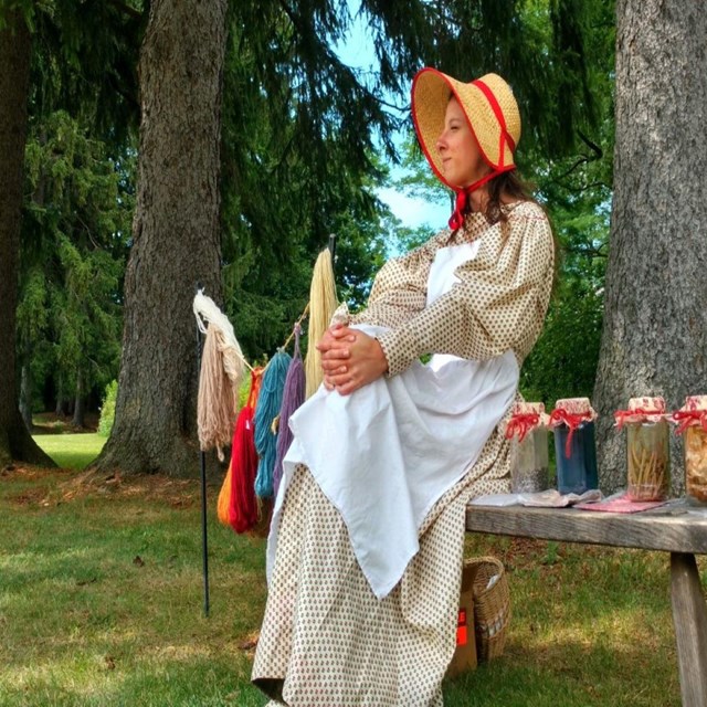 A park ranger in period clothing set up for a demonstration.