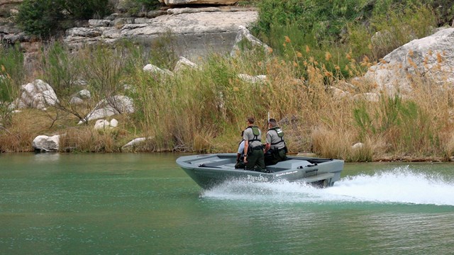 Park Rangers patrolling a river canyon.