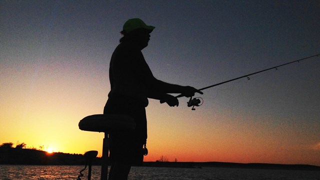 Silhouette of angler in the sunrise. Photo Credit: NPS / K Dunlap