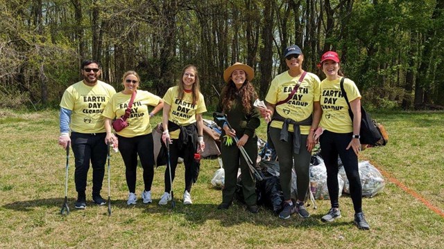 A group of people holding trash bags. 