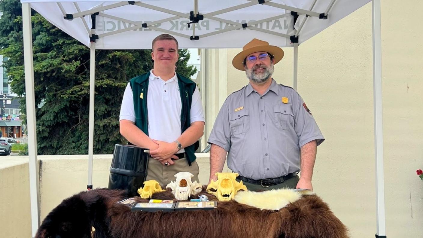 Park Ranger Burton and YCC Student Standing behind information desk