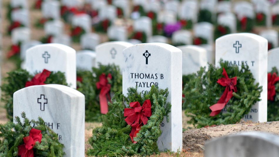 Rows of headstones decorated with wreaths