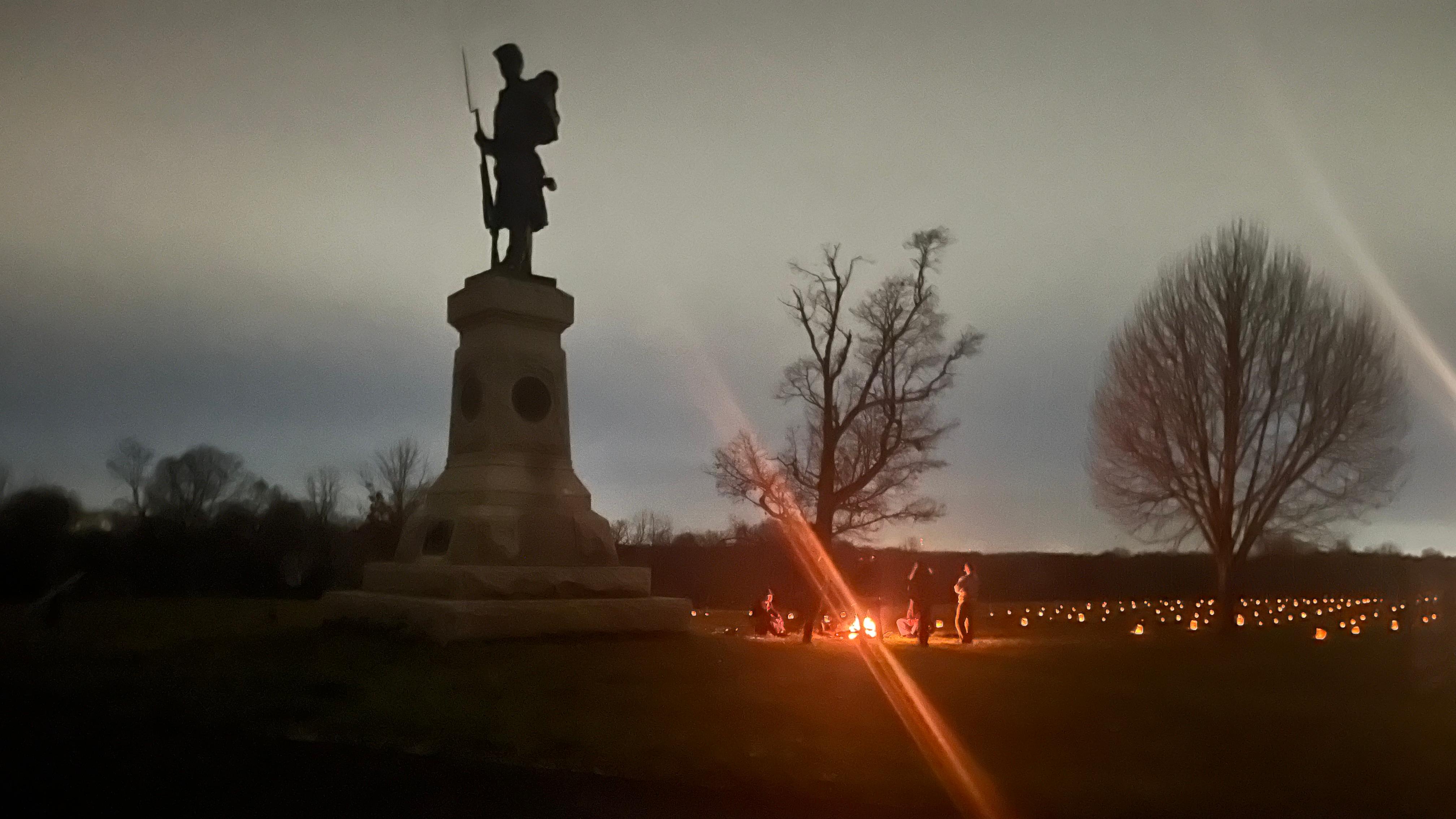 monument in low light with soldier posted on top