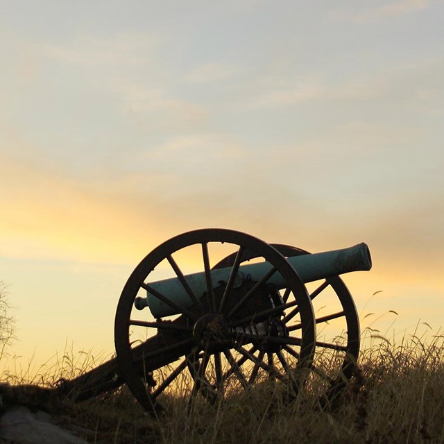 Cannon on the battlefield at sunset