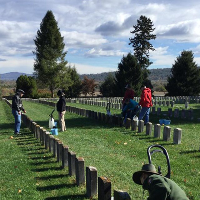 volunteers cleaning gravestones