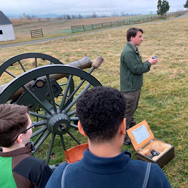 students listen to park ranger talk about Civil War cannons