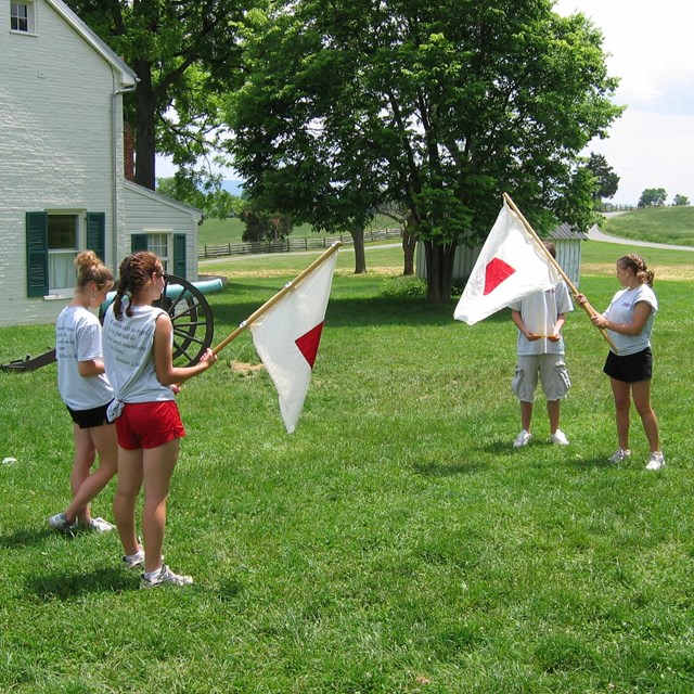 High school students using Civil War signal flags