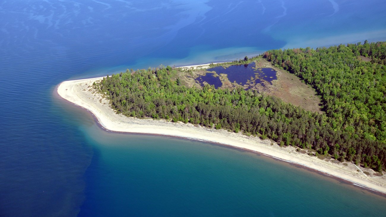 Aerial view of a sandy beach and lagoon on Michigan Island.