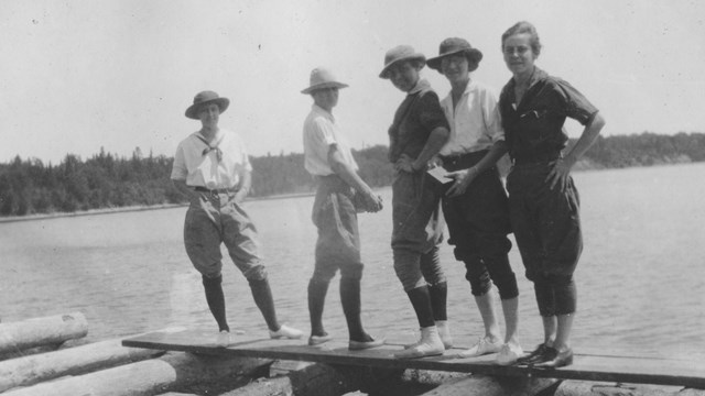 Old photo of 5 ladies on dock.