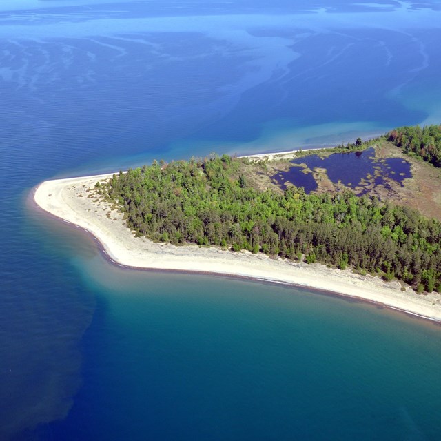 Aerial view of a sandy beach and lagoon on Michigan Island.