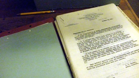 Photograph of an open archival folder with documents.