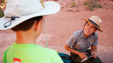 a ranger speaks with a child