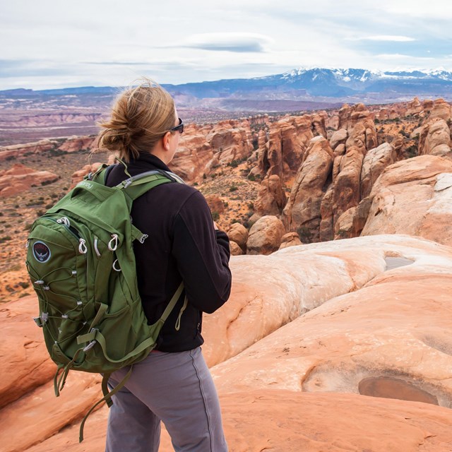 a hiker on a rock fin