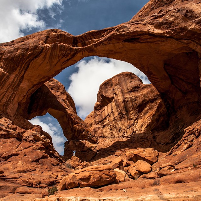 a large, double arch with clouds overhead