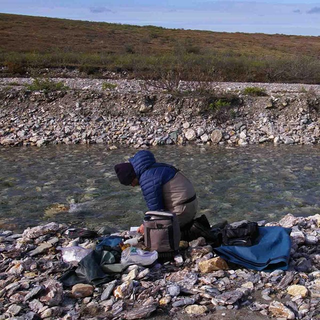 A researcher collecting data on a river.