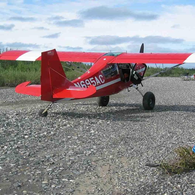 A small plane on the tundra and ready for action.